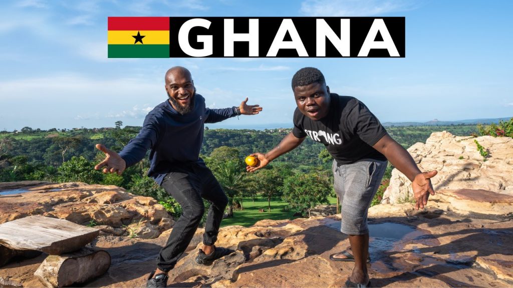 Tayo Aina poses with a man in Ghana during his Rediscover Africa Travel Tour
